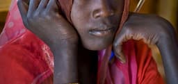 <p>Chad / Darfurian refugees from Sudan / Djabal camp  (17 766 refugees, 4681 families), 4 kilometers west from Goz Beida UNHCR sub-office located 217 km south from Abeche, located 900 kilometer east from N&#8217;Djamena the chadian capital. The camp, created on 4/6/2004, is located 80 km from the sudanese border. A pupil during a morning course, in Ali Dinnar primary school. The curriculum is the sudanese one. 690 pupils attend the school where 19 teachers are working. The buildings are not numerous enough. There are 11 classes for 7 classrooms. There are 6 primary schools in Djabal for 4496 pupils (2420 boys and 2076 girls). / UNHCR / F. Noy / December 2011</p>
