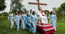 <p>Brazil. 2014. Brasilia.<br />
INRI Cristo’s disciples rolling him around on the compound grounds on his rolling pedestal.<br />
INRI (born Alvaro Theiss) takes his rst name from the initials of the inscription the Romans placed on the cross to spite him 2,000 years ago: Iesus Nazarenus Rex Iudaeorum, or Jesus of Nazareth, King of the Jews. The first awaking as the Christ came already in 1979 during a fast in Santiago of Chile, and INRI subsequently spent many years as a wandering preacher before settling in New Jerusalem, which is located outside of Brasilia.<br />
Most of the dozen or so disciples who live inside INRI’s compound are women. While the 69-year old Saviour and his followers live a private and secluded life, they are also busy disseminating his teachings to the world via the Internet, using YouTube, music videos and live broadcasts of sermons. From the book “The Last Testament”.</p>
